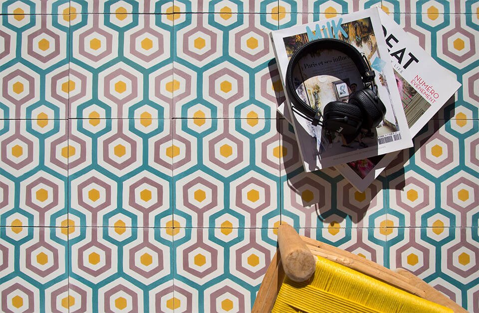 Magazine and headphones on retro funk colored cement tiles designed by Glazentile