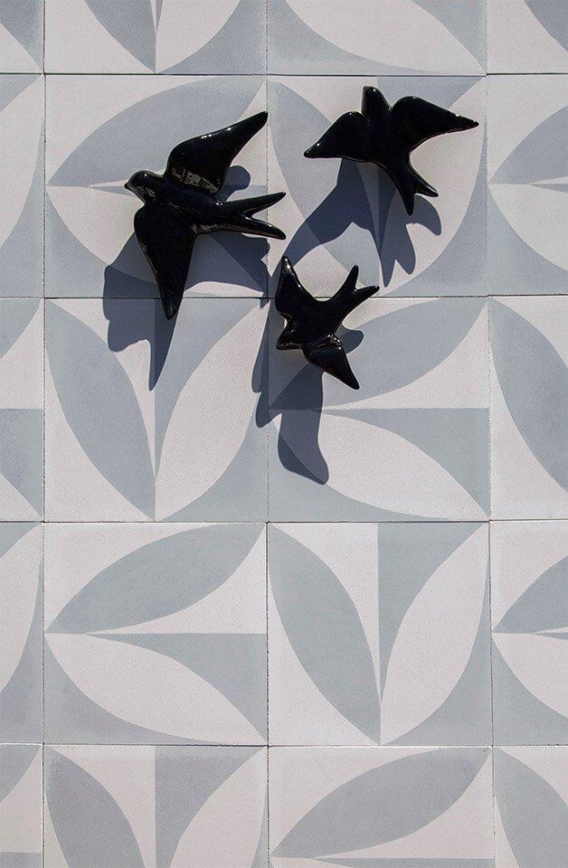Black porcelain birds on a gray tone cement tile designed by Glazentile