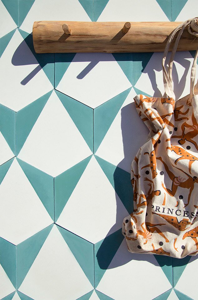 Hanging a tote bag on a backdrop of blue and white hexagonal cement tiles from Glazentile