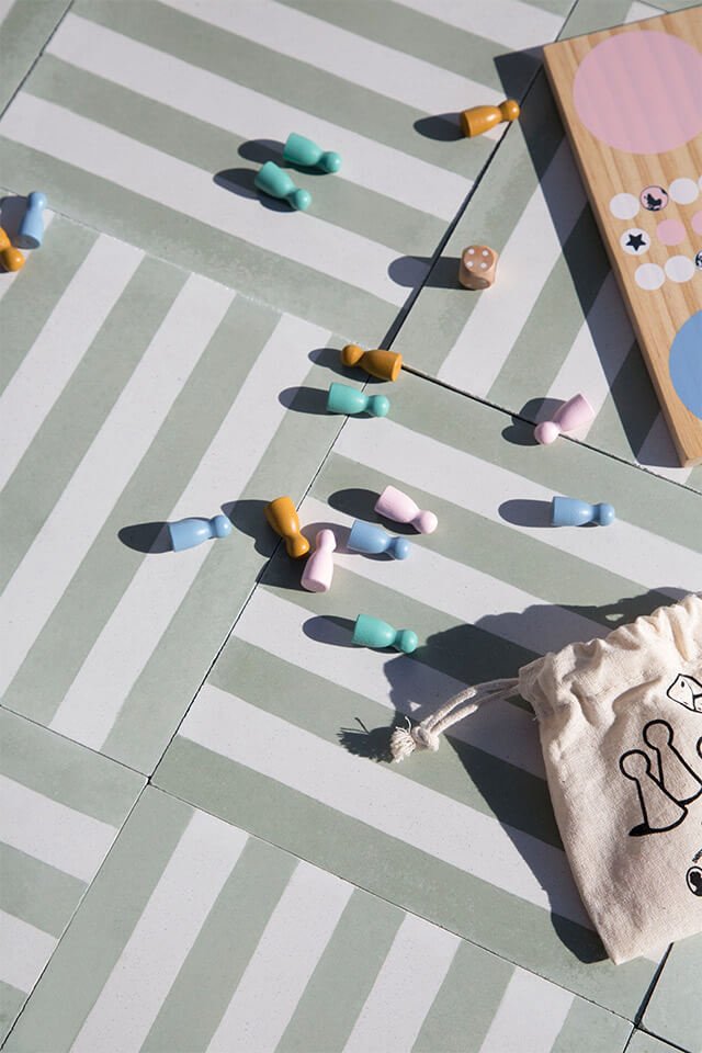 Pastel color board game on a mint green cement tile designed by Glazentile