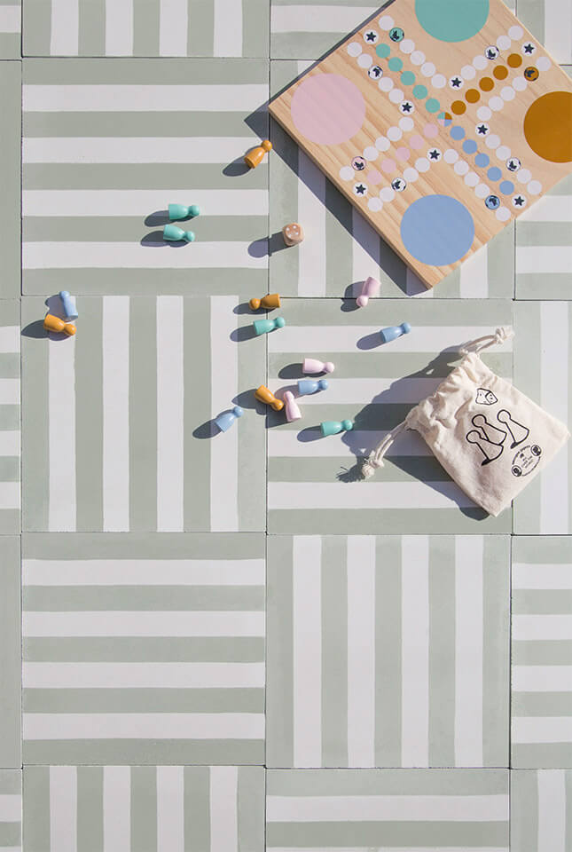Pastel color board game on a mint green cement tile designed by Glazentile