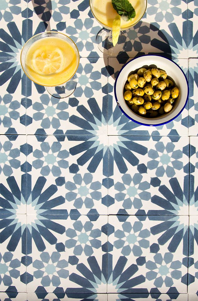 Blue andalusian style cement tile designed by Glazentile with green olives and cocktails